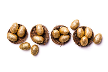 Golden glitter eggs in a nest. Easter background. Finance concept