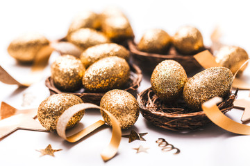 Golden glitter eggs in a nest. Easter background. Finance concept