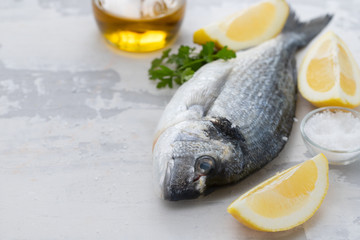 raw fish with olive oil and lemon background