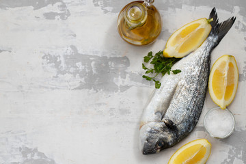 raw fish with olive oil and lemon background