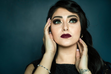 Portrait of Woman holding hands on face