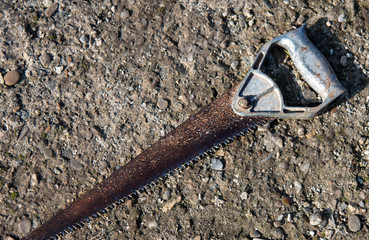 old rusty saw on the ground, metal saw
