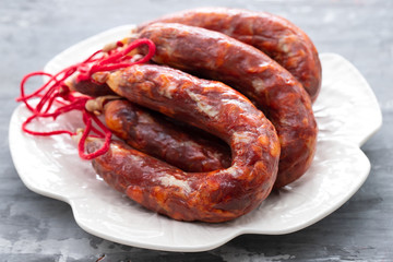 typical portuguese smoked sausages on beautiful white dish