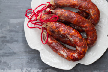 Fototapeta premium typical portuguese smoked sausages on beautiful white dish