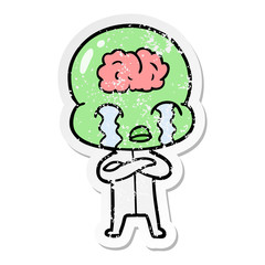 distressed sticker of a cartoon big brain alien crying