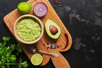 Bowl of guacamole with ingredients. Latin American traditional food.