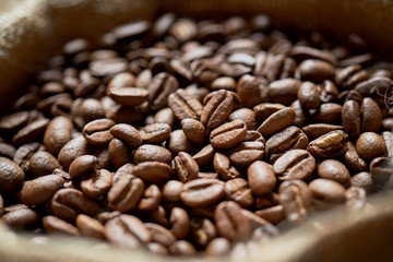 Ziarna kawy w jutowym worku na starych deskach © piotrszczepanek