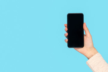 Crop hand of girl with smartphone 