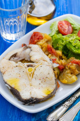 boiled fish with salad on white dish