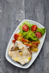 boiled fish with salad on white dish