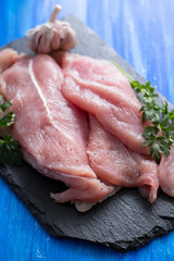 raw meat with parsley on black board