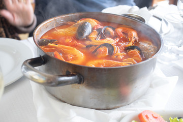 portuguese fish stew in iron pot