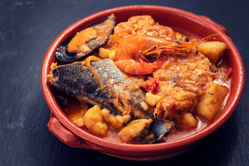 portuguese fish and seafood stew in dish on ceramic background