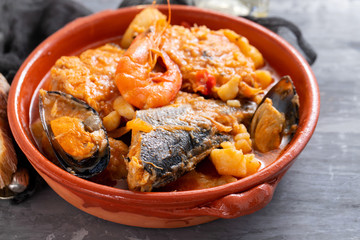 fish with vegetables in brown ceramic dish