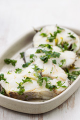 boiled perch with parsley and olive oil on dish