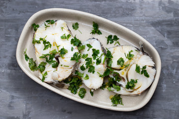 boiled perch with parsley and olive oil on dish