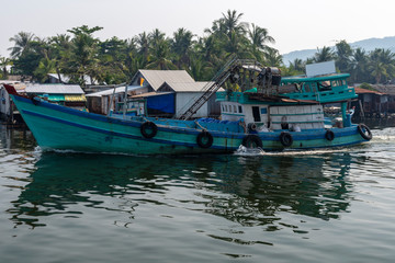 Fishing boat on the way out to the sea on Duong Dong river Phu Quoc Island.