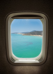 sunny sea landscape seen from window airplane.