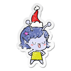 happy alien girl distressed sticker cartoon of a wearing santa hat