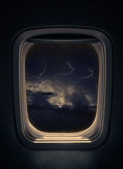 night thunderstorm with lightning  seen from window airplane.