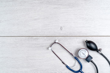 Medical stethoscope on gray wooden background