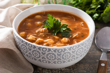 Harira soup in bowl on wooden table. Typical Moroccan food. Ramadán concept.