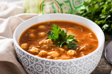 Harira soup in bowl on wooden table. Typical Moroccan food. Ramadán concept.