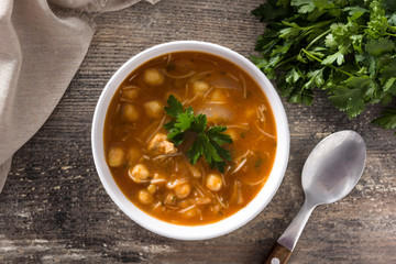Harira soup in bowl on wooden table. Typical Moroccan food. Ramadán concept. Top view