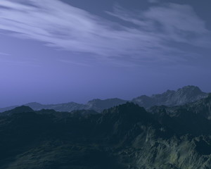 Mountains under cloudy sky at night.