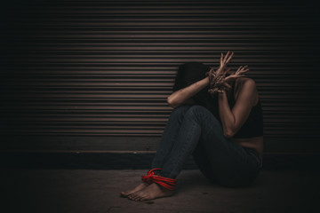 Asian hostage woman Bound with rope at night scene,The thieves kidnapped for ransom,thailand people