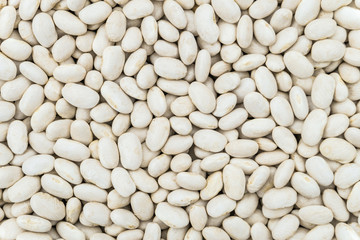 Dried white seeds of beans background. Food groceries product close-up.