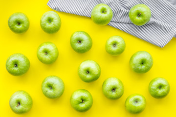 food pattern with green apples on yellow background top view