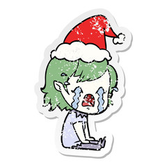 distressed sticker cartoon of a crying vampire girl wearing santa hat