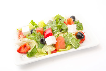 Square plate of greek salad isolated on white