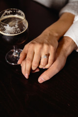 Real life proposal: Couple holding hands in a pub with a glass of beer to their side