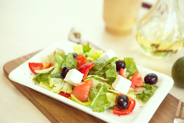 Greek salad with fresh vegetables, feta cheese and black olives