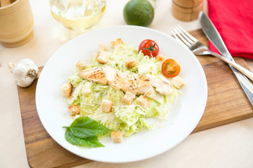 Fresh vegetable salad with grilled chicken breast - tomatoes, cucumbers, radish and mix lettuce leaves. Chicken salad.