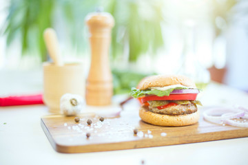 Delicious fresh homemade burger on wooden table