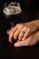 Real life proposal: Couple holding hands in a pub with a glass of beer to their side