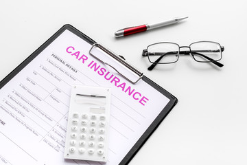 Car insurance form near glasses, calculator, pen on white background