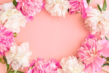 Flat lay composition with pink peonies on a pink background