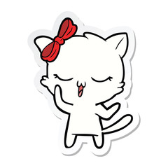 sticker of a cartoon cat with bow on head