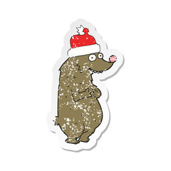 retro distressed sticker of a cartoon bear wearing christmas hat