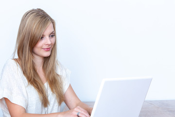 Young woman using a notebook computer indoors