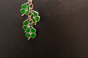 St Patrick's Day holiday black background. Green quatrefoils on the black background, St Patrick's...