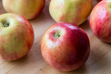 Fototapeta na wymiar Red apples on brown wooden background, natural food.