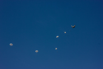 skydiver on blue sky white dome paratrooper aircraft