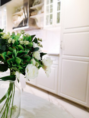 beautiful bouquet of flowers in a vase in a modern kitchen in bright colors.