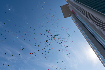 Hundreds of red, green, white and black ballons  realsed in the air on UAE flag Day