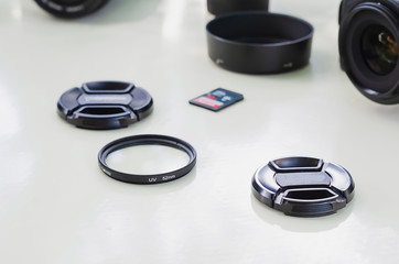 image of outdoor photographic equipment on a white table with natural light with assorted lenses